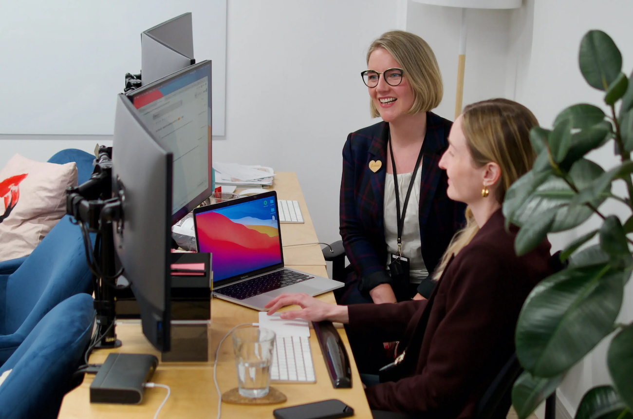 Atalanta's CEO, Eva Barboni, and COO, Elizabeth Ames, huddled around a computer